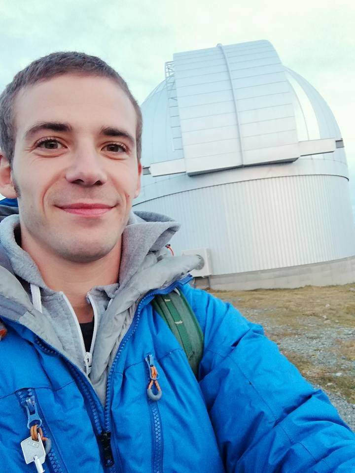 English guide Daniel from Stargaze Mackenzie with the MOA telescope, background of night sky and stars