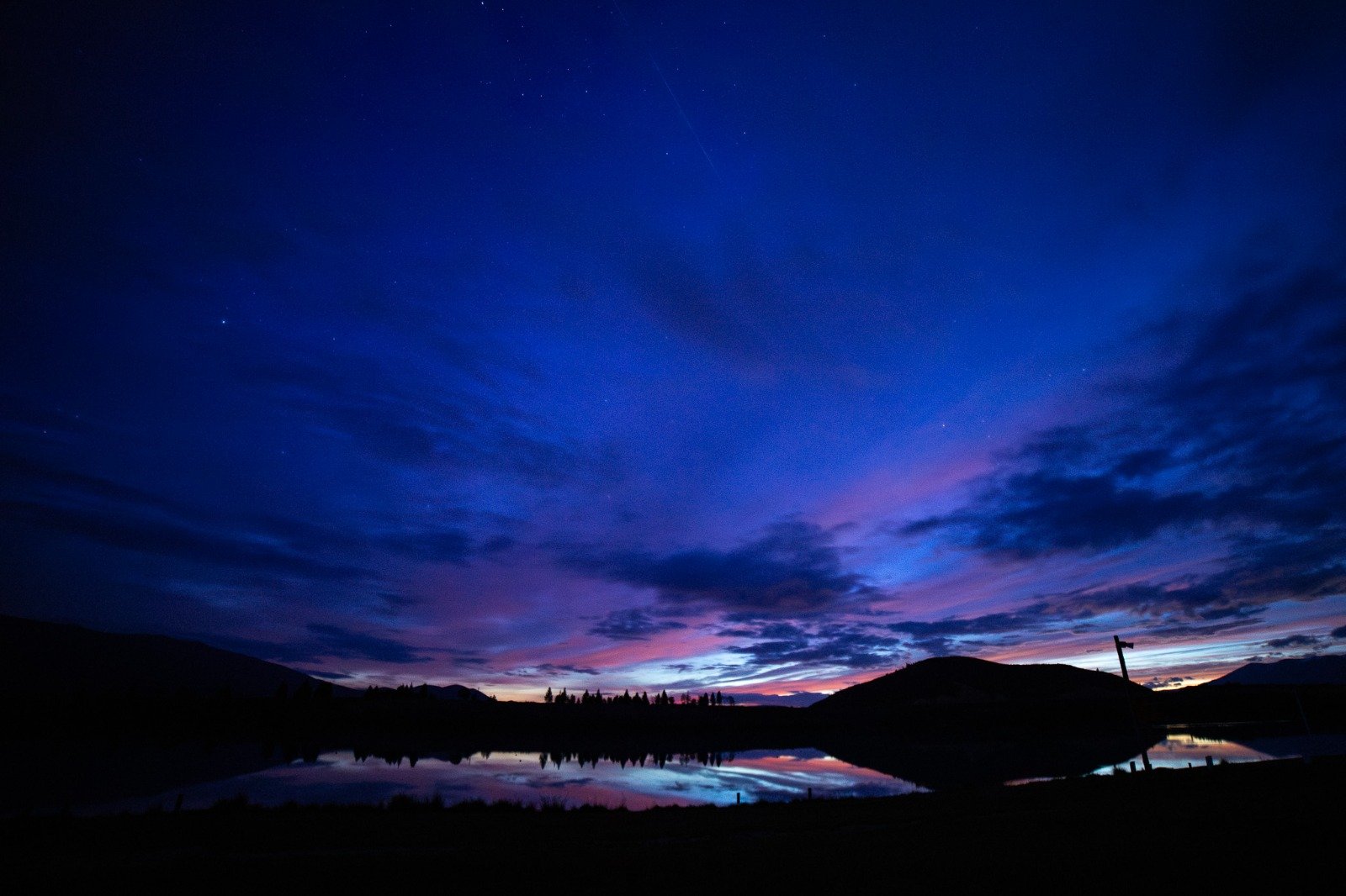 Twilight at Lake Ruataniwha with soft sunset colours reflecting across the calm lake surface